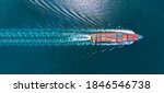 Aerial top view of cargo maritime ship with contrail in the ocean ship carrying container and running for export  concept technology freight shipping by ship smart service