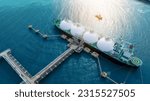 Small photo of LNG (Liquified Natural Gas) tanker anchored in Gas terminal gas tanks for storage. Oil Crude Gas Tanker Ship. LPG at Tanker Bay Petroleum Chemical or Methane freighter export import transportation