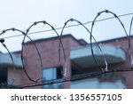 Small photo of Barbed Wire city prison house with harsh light