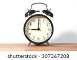 Small photo of It's nine o'clock already. Time to wake up and hurry. An image of a retro clock showing 9:00 am or pm.