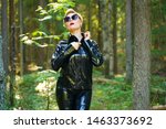 latex rubber fashion woman walking in the forest