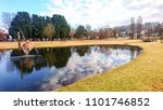 Reflections of park and sky in pond, Armidale, Australia 