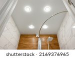 Stretch ceiling in the bathroom with built-in lighting.