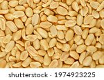 Roasted and salted peanuts, background, from above. Snack food, made from fruits of Arachis hypogaea, also groundnut, goober, pindar or monkey nut, with high oil content. Backdrop. Macro food photo.