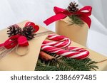 Christmas, New Year gifts. Presents. Beautiful boxes, ribbons and decorations. tree cones on white background. red. craft paper. Holiday. original. cinnamon. candy. Package Design 