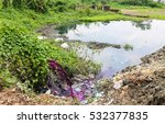 Small photo of DHAKA, BANGLADESH - MAY 23, 2016: Factory polution where water mixed with polluting pink and purple dyestuff is dumped in the lake without filtering
