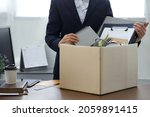 Small photo of Resignation concept.Businesswoman packing personal company belongings when she deciding resignation change of job or fired from the company.