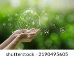 Sustainable development goal (SDGs) concept. Hands holding Global communication network with Environment icon on a green background. Green technology and Environmental technology.