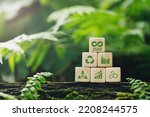 Circular economy concept.wooden cubes with a Circular economy icon on a green background. circular economy for future growth of business and design to reuse and renewable material resources.