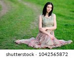 Beautiful girl in a long evening dress. Girl in the spring fores