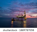 Small photo of Aerial view offshore drilling rig (jack up rig) at the offshore location during sunset