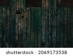 Small photo of Old vintage green wooden door with obliterated paint and copper handle