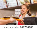 Restaurant worker serving two fast food meals with smile. woman holding tray with salads at fast food restaurant