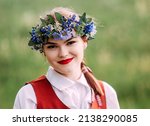 Small photo of Latvian folk girls in traditional costume. Latvia summer. Symbolism of Latvia for Ligo holiday. Midsummer in Latvia. Traditional Latvian midsummer food. Celebration of Ligo in june decorating home wit