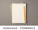 Above photo of two empty notebooks and yellow pencil isolated on the grey background