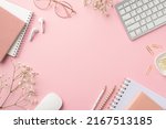 Small photo of Business concept. Top view photo of workplace keyboard computer mouse reminders clips pencils glasses earbuds white gypsophila flowers on isolated pastel pink background with copyspace in the middle