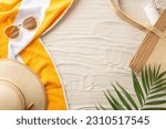 Small photo of Soak up the sun. Top view of sunbathing essentials: sunglasses, sunhat, beach bag, sunscreen, towel, natural palm leaves. Sandy shore backdrop with an empty space for text or ads