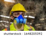 Small photo of A Engineer industry wearing safety uniform ,black gloves ,gas mask feel suffocate when under checking chemical tank in industry factory work.