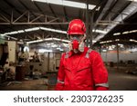 Portrait industry worker with safety uniform protective wearing gas mask to safe before start work to check chemical or gas in factory is industry safety concept. 