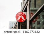 Small photo of Melbourne, Australia - Aug 9, 2017: An extensile STOP sign on the tram.