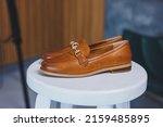 Small photo of Vintage Women's Loafer Shoes. Closeup. Advertising shot. Leather brown shoes. Concept closeup shoes. Isolated object close up on white background. Back shoe view.