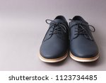 Men's Classic Shoes On A Gray...