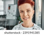 Small photo of portrait of cheerful stylish queer person with facial piercing looking at camera in modern office