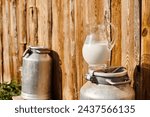 Small photo of object photo of metal churn and jar of fresh milk placed outside nearby village house on modern farm