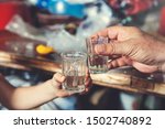 Small photo of man and boy hands glass of vodka