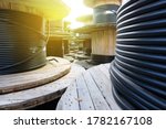 Wooden Coils Of Electric Cable Outdoor. High and low voltage cables in the storage