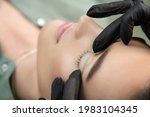 Small photo of Master fits white curl for lashes. Eyelash Care Treatment: lifting and curling, lash lamination and extension for lashes. Close-up of beauty model's face during lash lift laminating botox procedure.