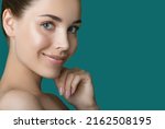Portrait of beauty model with make-up, formed eyebrows  and long eyelashes. Beautiful young smiling women face with perfect fresh skin. Spa, skincare and wellness. Selective focus. Close-up.
