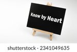 Small photo of Text sign showing know by heart blackboard on wood desk background. Chalkboard words write know by heart on table for copy space.