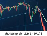 Small photo of Diagram representing red crashing stock market volatility of crypto trading, where red candlesticks going down without resistance, market fear and downtrend on blue display background