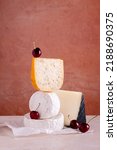 Small photo of Variety of cheeses with brie, manchego, camembert on stone background