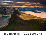 Sunset above the Husfjellet Mountain on Senja Island in northern Norway with views over surrounding fjords and mountains.