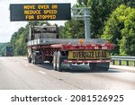 Small photo of Gaston, USA - July 6, 2021: Interstate highway i26 26 in South Carolina with large truck trailer sign for oversize load and move over or reduce speed for stopped vehicles