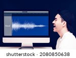 Small photo of vocal, voice recording concept. asian male singer singing beside waveform on computer display look like his voice become digital waveform on digital audio workstation application