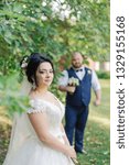 Small photo of Newlyweds on their wedding day stand apart from each other.