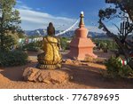 Amitabha Stupa, Buddha Statue and Prayer Flags with Distant Red Rock Landscape in Peace Park, Sedona Arizona