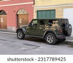 Small photo of Cremona, Italy - May 5 2023 Sarge green Jeep Rubicon 4x4 offroad parked in the street.