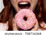 woman eating a donut close-up, delicious, sweet, sweet tooth                               