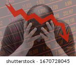 Concept of financial crisis . Business man or market operator or trader or middle aged man holding his head in his hands while the markets plunge on a descending stock curve background.