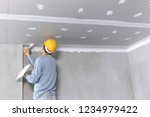 Craftsman working
with plaster gypsum ceiling for interior build gypsum board ceiling