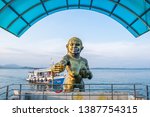 Small photo of Rayong, Thailand - March 31, 2019: View of entrance pier gate to Samed Island with the Pisue Samutr sculpture or a female yak who can transmute herself into a beautiful girl in Rayong, Thailand.