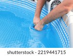 Small photo of Man cleans skimmer for the frame pool. Contaminated pool cleaning concept.