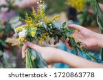 Small photo of Making a Festive flower wreath, circlet of flowers, festival coronet of flowers on a bright sunny afternoon. Preparing for Midsummer night fest, or bachelorette party idea. How to Make a Flower Crown