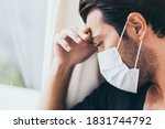 Small photo of Upset depressed melancholy sad crying man in protective face mask with crying during serious illness, coronavirus outbreak and flu covid19 epidemic. Patient guy stay at hospital, get stress, lonely