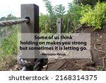 Small photo of Inspirational motivational quote - Some of us think holding on makes you strong but sometimes it is letting go. With broken rope of fence in the end of cliff edge. Words of wisdom.