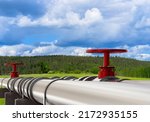 Small photo of Gas pipeline outdoor. Propane gas pipes. Steel pipeline in open air. Metal pipes on concrete supports. Long gas pipeline next to forest. Supplying city with propane concept.